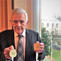 Provost Martin Brennan with 'Our 2020' medals/tokens for Inverclyde school pupils